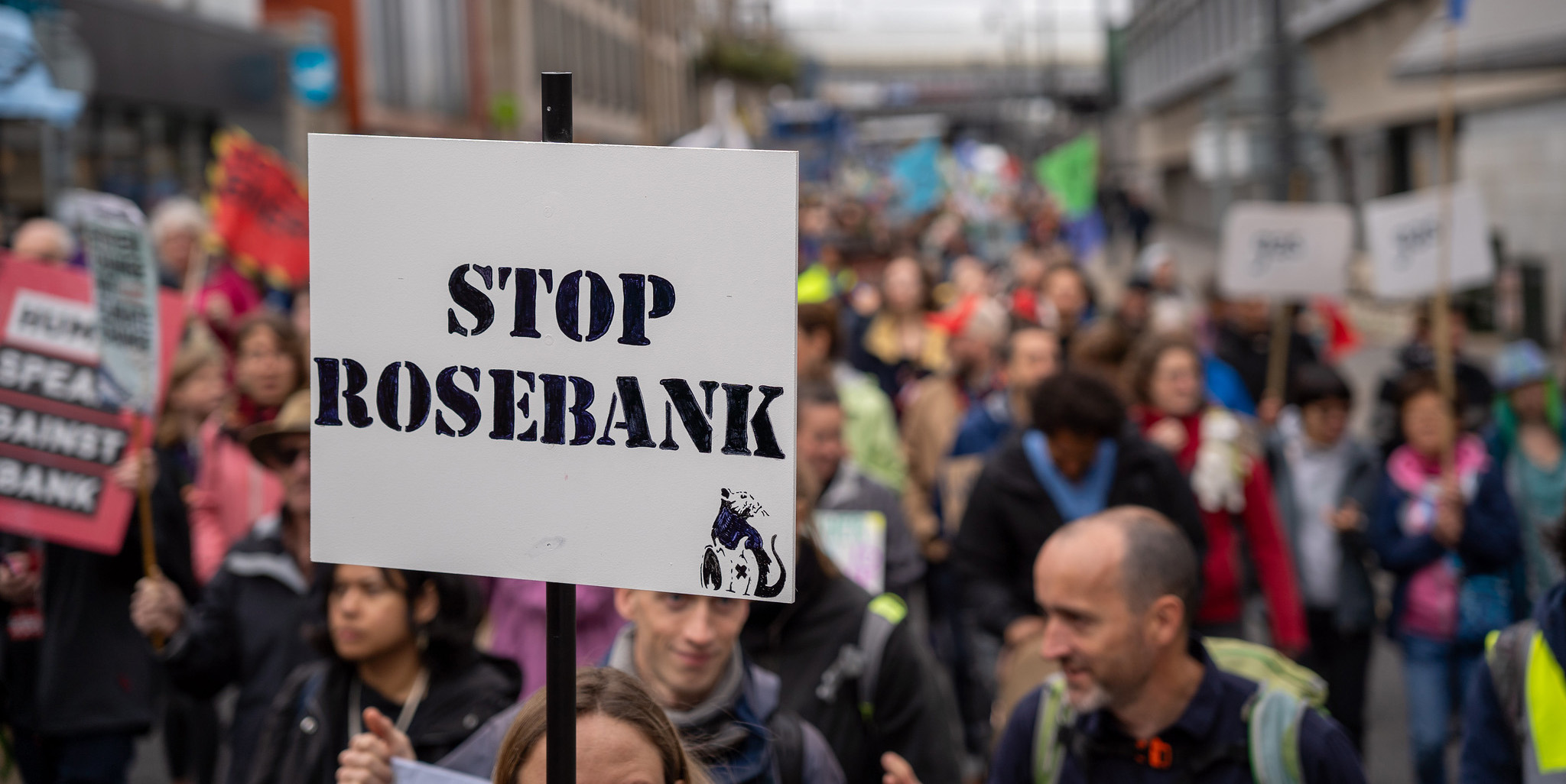 A Stop Rosebank sign help up during a climate march