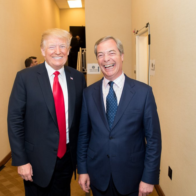 Nigel Farage and Donald Trump standing together smiling at the camera.