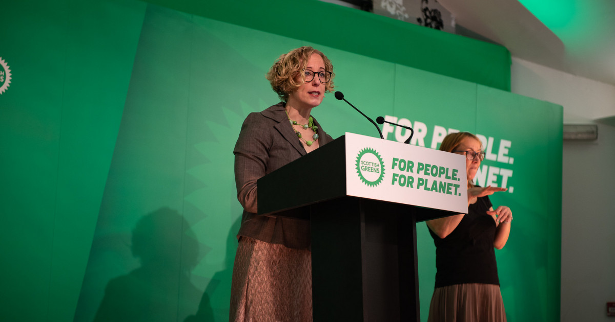 Lorna Slater standing at a podium at autumn conference 